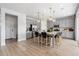 Modern kitchen with gray cabinets, stainless steel appliances, a large island, and pendant lighting at 8816 Whiteclover St, Littleton, CO 80125