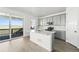 Bright kitchen boasts grey cabinetry, stainless appliances, white backsplash and adjacent access to patio with views at 8816 Whiteclover St, Littleton, CO 80125