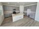 Well-lit kitchen features gray cabinets, white countertops, and a central island at 8816 Whiteclover St, Littleton, CO 80125
