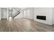 Bright living space with hardwood floors, modern fireplace, and staircase at 8816 Whiteclover St, Littleton, CO 80125