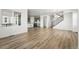 Open-concept living area featuring modern hardwood floors and plenty of natural light at 8816 Whiteclover St, Littleton, CO 80125