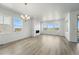 Open living room with hardwood floors, fireplace, large windows with beautiful outdoor views at 8816 Whiteclover St, Littleton, CO 80125