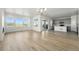 Bright, open-concept living space featuring hardwood floors, large windows, and a modern kitchen at 8816 Whiteclover St, Littleton, CO 80125
