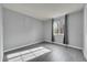 Well-lit bedroom featuring gray walls and wood-look flooring at 14657 E Oregon Dr, Aurora, CO 80012