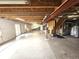 Spacious unfinished basement area with stairs, windows, and utility connections at 21580 Longs Peak Ln, Parker, CO 80138