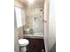Updated bathroom featuring a marble-tiled shower with glass doors and wood-look flooring at 21580 Longs Peak Ln, Parker, CO 80138