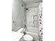 Bathroom featuring marble-look tile surround on the tub with shampoo nooks at 21580 Longs Peak Ln, Parker, CO 80138