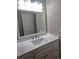Bathroom vanity featuring white cabinetry, marble countertop, and modern fixtures at 21580 Longs Peak Ln, Parker, CO 80138