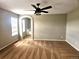 Bedroom featuring carpeting, an overhead fan, and an archway leading to the en suite bathroom at 21580 Longs Peak Ln, Parker, CO 80138