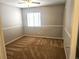 Cozy bedroom features a large window for natural light, neutral walls and carpeted floor at 21580 Longs Peak Ln, Parker, CO 80138