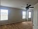 Bright bedroom with three windows, neutral walls and a ceiling fan at 21580 Longs Peak Ln, Parker, CO 80138