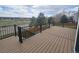 Spacious deck features black metal railings overlooking a green space at 21580 Longs Peak Ln, Parker, CO 80138