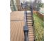 Multi-level deck featuring stairs leading to grassy backyard and black metal railings at 21580 Longs Peak Ln, Parker, CO 80138