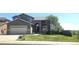 Beautiful two-story home with stone accents, a two-car garage, and a well-manicured front lawn at 21580 Longs Peak Ln, Parker, CO 80138