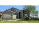 Charming two-story home with stone accents, a two car garage, and a well manicured lawn at 21580 Longs Peak Ln, Parker, CO 80138