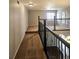 Spacious hallway with carpeted flooring, wooden banister and a peek at hardwood floors at 21580 Longs Peak Ln, Parker, CO 80138