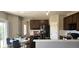 Eat-in kitchen with dark wood cabinets, granite countertops, stainless steel appliances, and access to the deck at 21580 Longs Peak Ln, Parker, CO 80138
