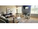 Inviting living room with a fireplace, neutral walls, and two accent chairs providing a cozy space at 21580 Longs Peak Ln, Parker, CO 80138
