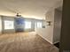 A spacious living room showcases carpet, a fireplace, and ample natural light at 21580 Longs Peak Ln, Parker, CO 80138