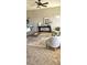 Comfortable living room with stylish furniture, modern rug, and a ceiling fan at 21580 Longs Peak Ln, Parker, CO 80138
