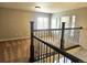 View of second story with railing, and the living room below with hardwood floors and natural light at 21580 Longs Peak Ln, Parker, CO 80138