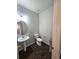A clean half bathroom offers a pedestal sink and tile flooring at 21580 Longs Peak Ln, Parker, CO 80138