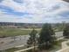Scenic view from a large window, showcasing green spaces and a distant skyline at 21580 Longs Peak Ln, Parker, CO 80138