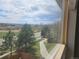 Wonderful outdoor view of green spaces and walkways through a window at 21580 Longs Peak Ln, Parker, CO 80138