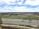 Scenic view from a window, showcasing a green landscape, road, and cloudy skies at 21580 Longs Peak Ln, Parker, CO 80138