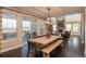 Open-concept dining area featuring a wooden table, view windows, and seamless flow into the living room at 22435 Boundstone Dr, Parker, CO 80138