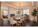 Bright dining room with a stone fireplace, modern chandelier and rich hardwood floors at 22435 Boundstone Dr, Parker, CO 80138