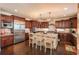 Gourmet kitchen boasting a large island, stainless appliances, and dark wood cabinets at 22435 Boundstone Dr, Parker, CO 80138