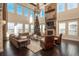 Spacious living room features high ceilings, large windows, a stone fireplace, and a decorated Christmas tree at 22435 Boundstone Dr, Parker, CO 80138