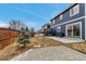 View of a spacious backyard featuring a blue house, patio, and grassy area, perfect for outdoor activities at 4539 Lyndenwood Cir, Highlands Ranch, CO 80130