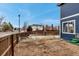 Spacious backyard with wooden fences, a small firepit, and potential for outdoor entertaining at 4539 Lyndenwood Cir, Highlands Ranch, CO 80130