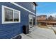 Cozy backyard patio and deck featuring a blue house, perfect for outdoor relaxation at 4539 Lyndenwood Cir, Highlands Ranch, CO 80130