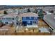 Aerial view of a quaint backyard with a patio, fenced perimeter, and well-kept lawn at 4539 Lyndenwood Cir, Highlands Ranch, CO 80130