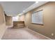 Finished basement featuring neutral carpet and a bar counter at 4539 Lyndenwood Cir, Highlands Ranch, CO 80130