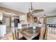Comfortable dining room with a wooden table, a view into the kitchen and an adjacent staircase at 4539 Lyndenwood Cir, Highlands Ranch, CO 80130