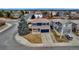 Inviting two-story home boasts a blue exterior, a spacious driveway, and a well-maintained lawn at 4539 Lyndenwood Cir, Highlands Ranch, CO 80130