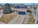 Stunning two-story home featuring a blue exterior, charming front porch, and concrete driveway at 4539 Lyndenwood Cir, Highlands Ranch, CO 80130