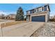 Charming two-story home with blue siding, brick accents, and a spacious driveway at 4539 Lyndenwood Cir, Highlands Ranch, CO 80130