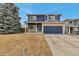 Attractive two-story home featuring blue siding, brick accents, and a well-manicured front lawn at 4539 Lyndenwood Cir, Highlands Ranch, CO 80130