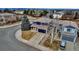 Charming two-story home features a blue exterior, spacious driveway, tile roof, and manicured landscaping at 4539 Lyndenwood Cir, Highlands Ranch, CO 80130
