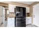 Well-lit kitchen features stainless steel appliances, white cabinetry, and neutral countertops at 4539 Lyndenwood Cir, Highlands Ranch, CO 80130