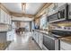Well-lit kitchen featuring modern appliances and tile floors with a view into the dining area at 4539 Lyndenwood Cir, Highlands Ranch, CO 80130