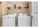 Practical laundry room equipped with side-by-side washer and dryer at 4539 Lyndenwood Cir, Highlands Ranch, CO 80130