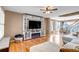 Bright living room with hardwood floors, a cozy sectional sofa, entertainment center and dining area at 4539 Lyndenwood Cir, Highlands Ranch, CO 80130