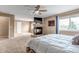 Spacious main bedroom featuring a fireplace, ceiling fan, and plush carpet at 4539 Lyndenwood Cir, Highlands Ranch, CO 80130