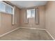 This bedroom features neutral walls, carpet, two windows, and curtains at 611 Winona Ct, Denver, CO 80204